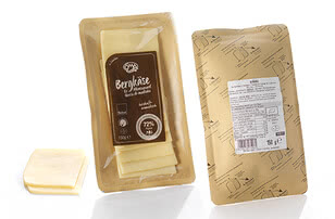 The image displays a packet of Bergkäse, a traditional alpine-style cheese, from which several wedges have been removed.