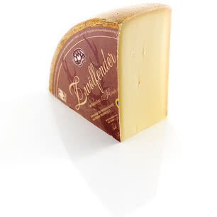 The image displays a wedge of our Zwiebelfelder cheese, carefully aged for a minimum of 12 months.