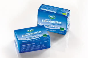 The image presents two packages of Allgäuer Bauernbutter, a traditional farm-style butter from the Allgäu region, clearly labelled “sour milk”.
